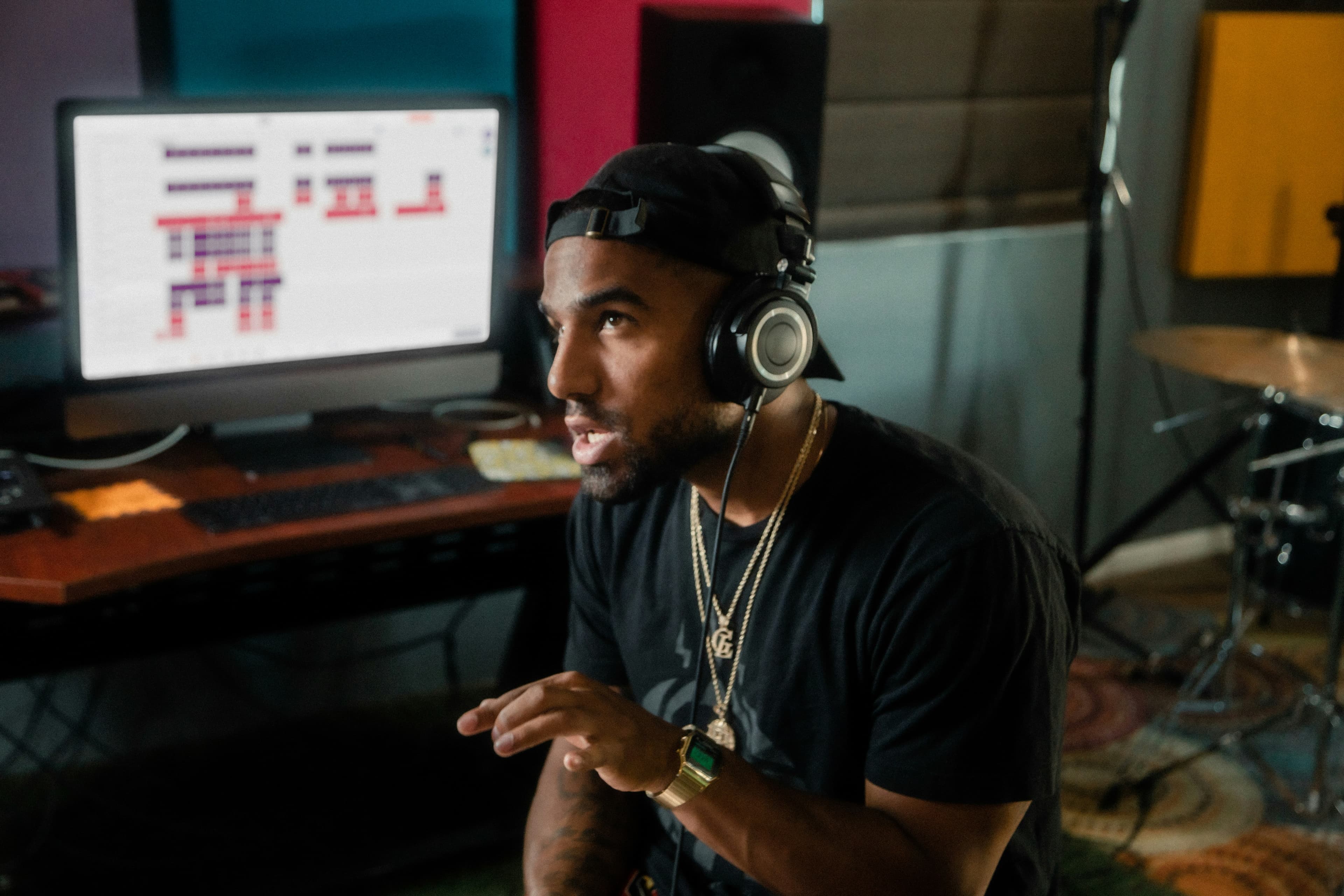 Artist wearing headphones in a studio, listening back to a track