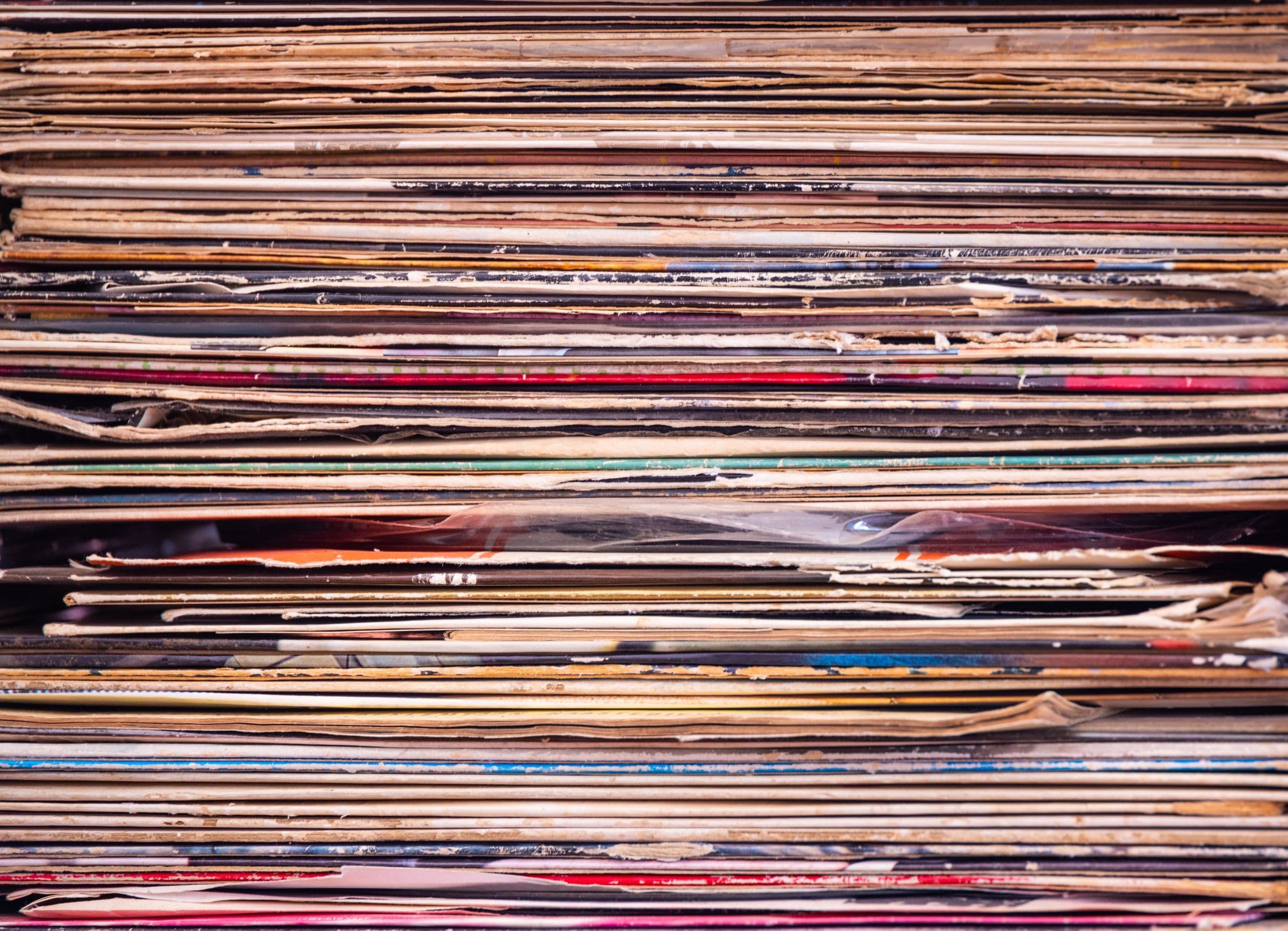 Close-up of a tall stack of vinyl records