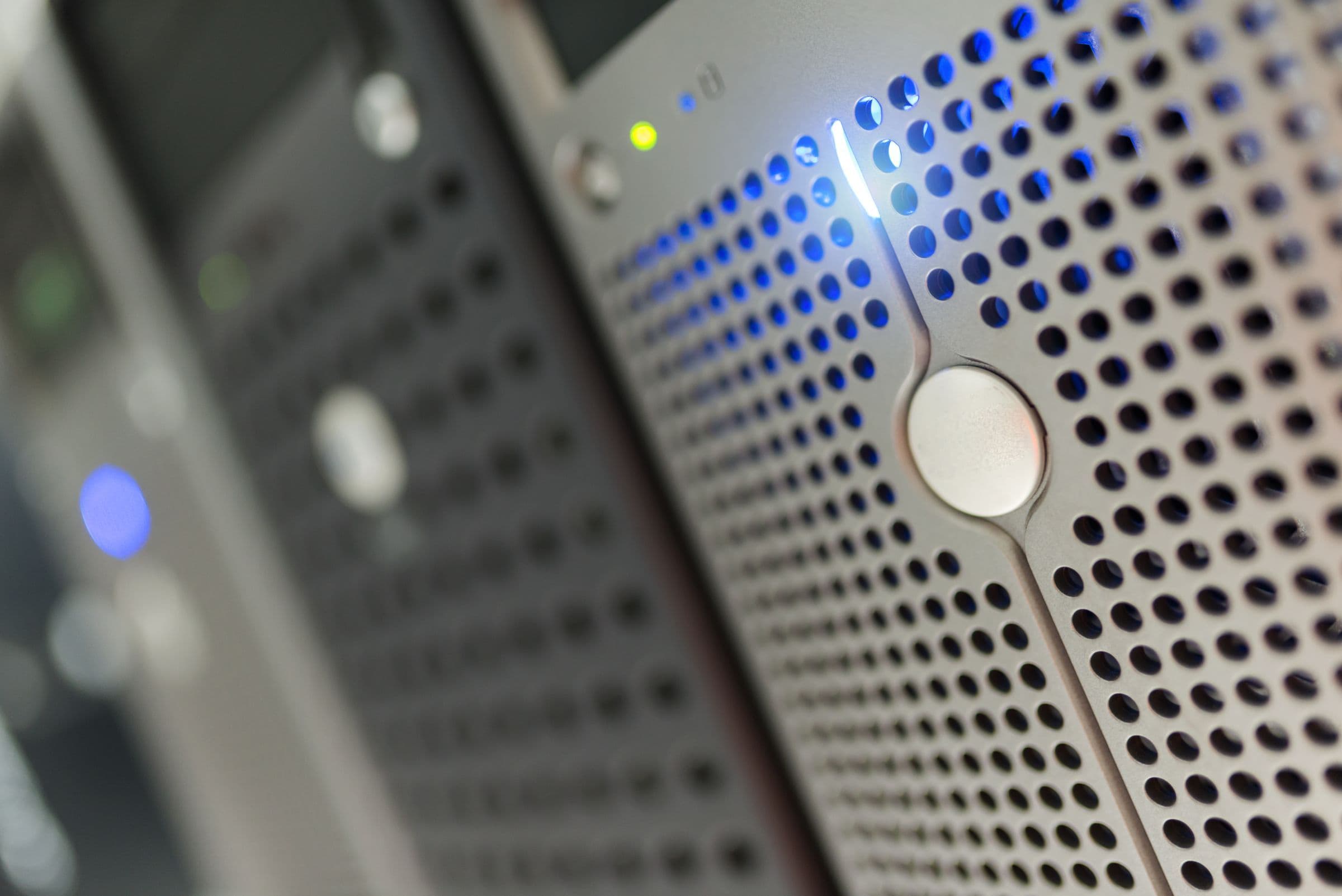 Close-up of a server rack with rows of blue indicator lights