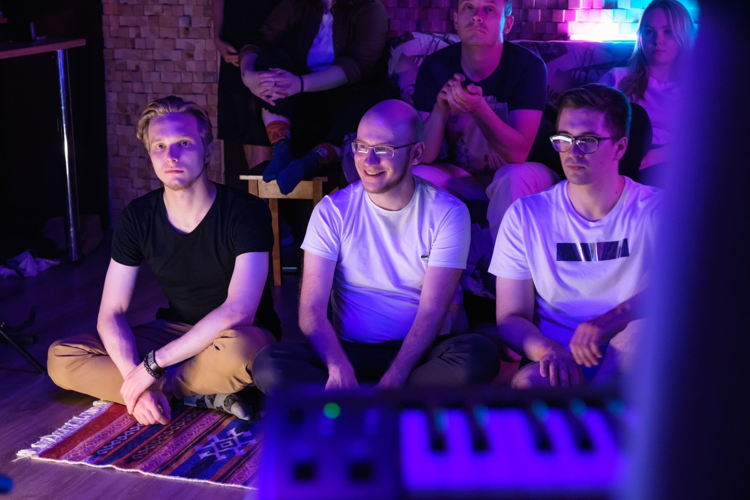 Small audience sitting close to the stage at an intimate indoor gig